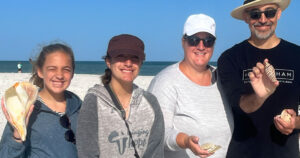 Very happy family shelling on a barrier island finding a huge whelk and rare junonia