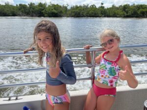 Kids enjoying a dolphin boat tour on Marco Island