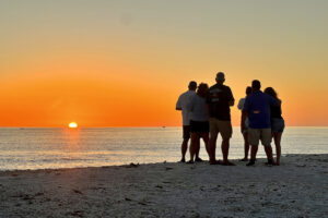 Family on a private tour enjoying a picturesque Marco Island sunset.