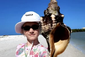 Great hat and a huge horse conch shell