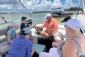 Family learning about shells on a Marco Island boat tour