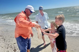 Learning from a naturalist guide about a moon jellyfish