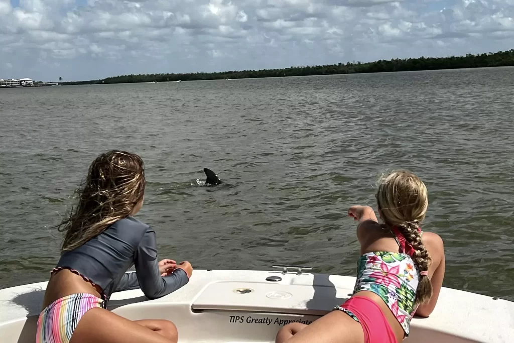 Two kids watching dolphins in Marco Island Up Close