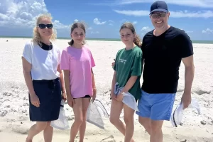 Family sand dollar shelling at Caxambas Pass