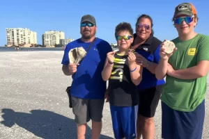 family shelling for sand dollars