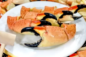 cracking stone crabs with a wooden mallet